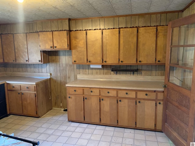 1368 Pritchard Rd, Wingo, KY 42088 - kitchen with brown cabinetry, wood walls, and light countertops