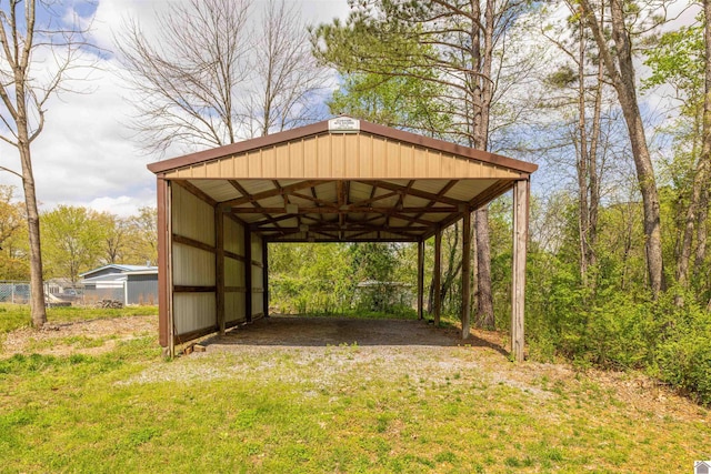 view of outdoor structure featuring a carport and driveway