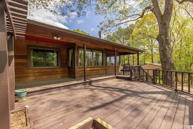 deck with an outdoor structure and a storage shed