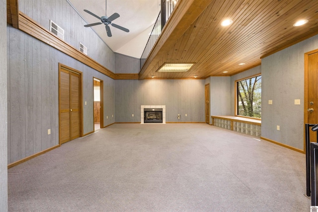 unfurnished living room featuring recessed lighting, a tile fireplace, a towering ceiling, visible vents, and a ceiling fan