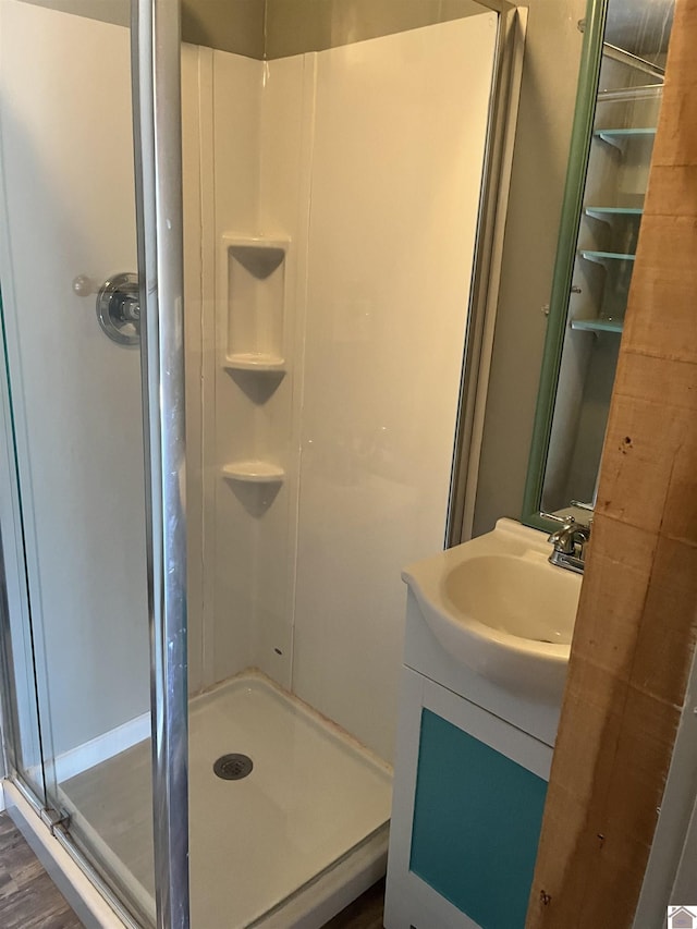 full bath featuring vanity and a shower stall