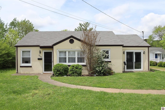 316 S 13th St, Murray, KY 42071 - view of front of home with roof with shingles, a front yard, and stucco siding