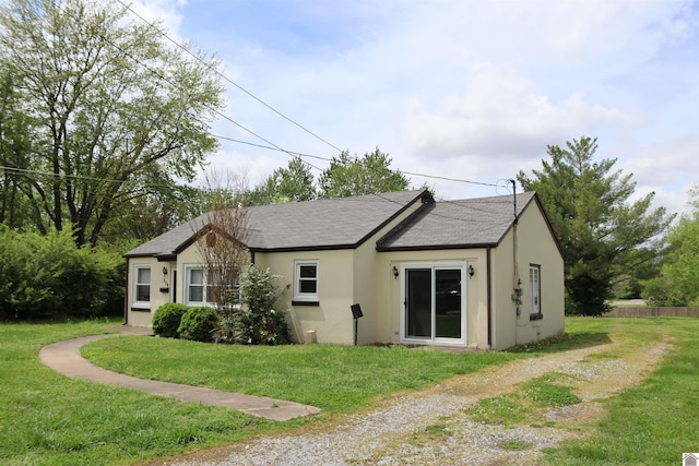 316 S 13th St, Murray, KY 42071 - exterior space featuring stucco siding, roof with shingles, and a yard
