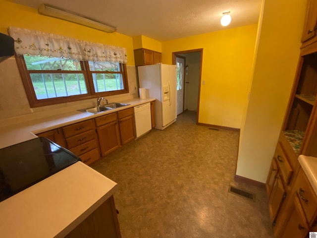 10091 Scale Rd, Benton, KY 42025 - kitchen with brown cabinets, a sink, visible vents, light countertops, and white appliances