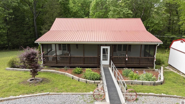 252 Creekview Dr, Murray, KY 42071 - view of front of house featuring a forest view, metal roof, and a front lawn