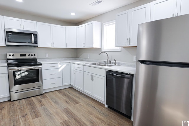 kitchen with recessed lighting, appliances with stainless steel finishes, light countertops, a sink, and visible vents