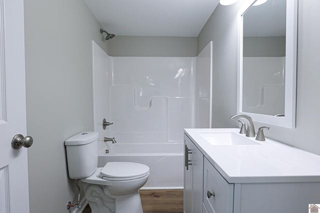 full bath with shower / bathing tub combination, wood finished floors, toilet, and vanity