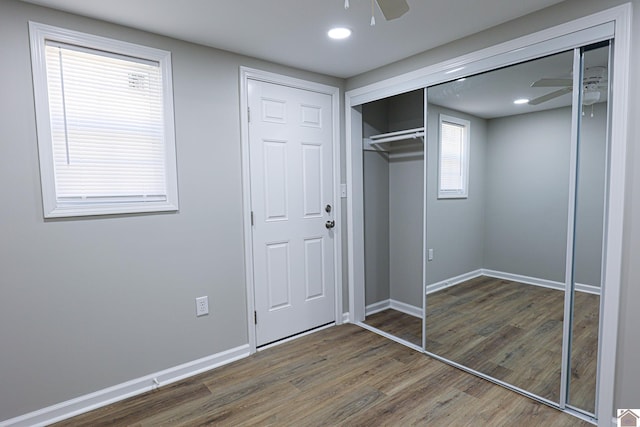 unfurnished bedroom featuring recessed lighting, wood finished floors, a closet, ceiling fan, and baseboards