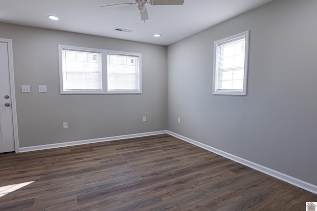 spare room with visible vents, baseboards, recessed lighting, dark wood finished floors, and a ceiling fan