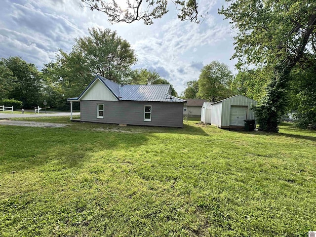 view of home's exterior featuring a detached garage, a storage shed, and a lawn