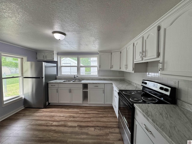 kitchen with a textured ceiling, stainless steel appliances, dark wood-style floors, and a sink