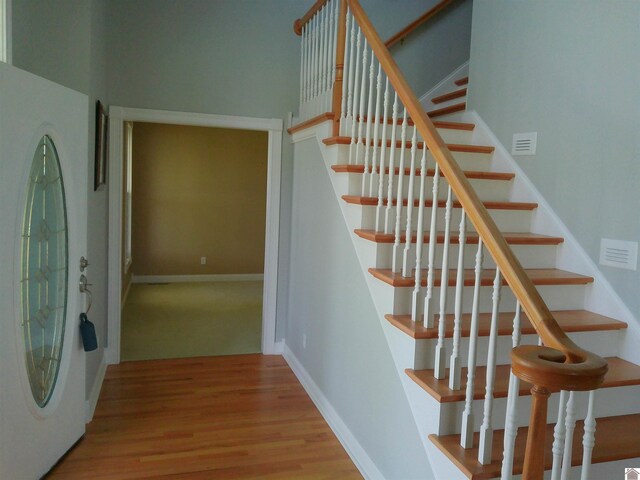 stairway featuring baseboards and wood finished floors