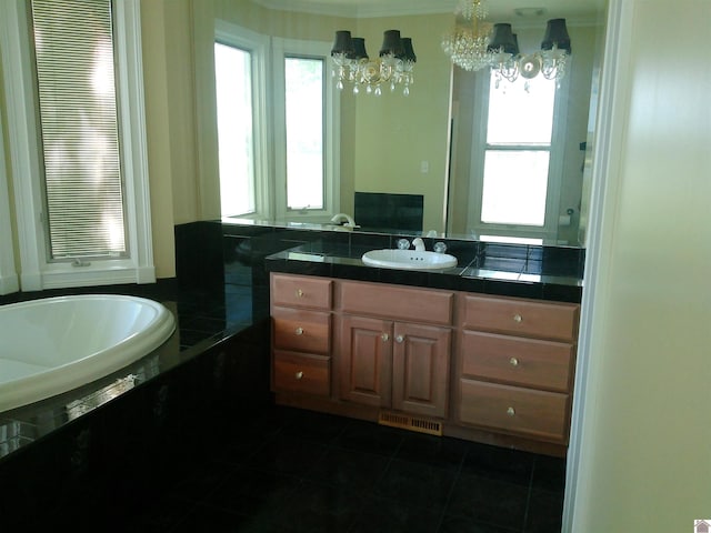 full bath with tile patterned floors, a notable chandelier, vanity, and a healthy amount of sunlight