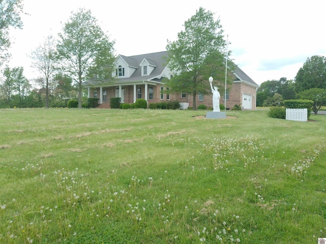 view of front of house with brick siding, a front lawn, and an attached garage