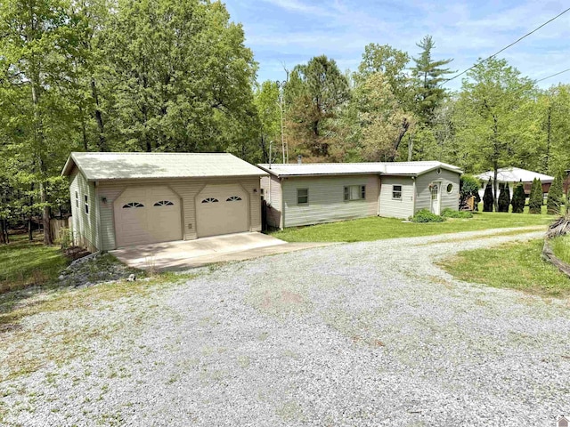124 Miller Ln, Gilbertsville, KY 42044 - single story home with a detached garage, a front lawn, and an outbuilding