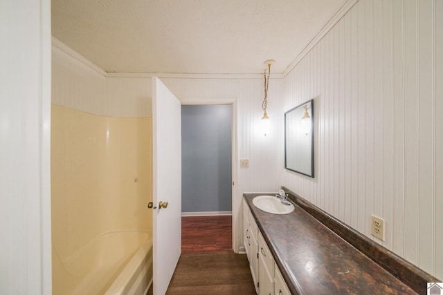 full bathroom featuring wood finished floors, vanity, and crown molding