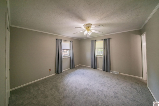spare room with visible vents, ceiling fan, ornamental molding, and carpet flooring