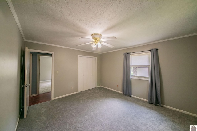 unfurnished bedroom with carpet floors, a closet, a ceiling fan, a textured ceiling, and crown molding
