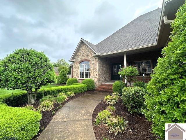 57 Rippling Creek Dr, Murray, KY 42071 - doorway to property with stone siding and covered porch