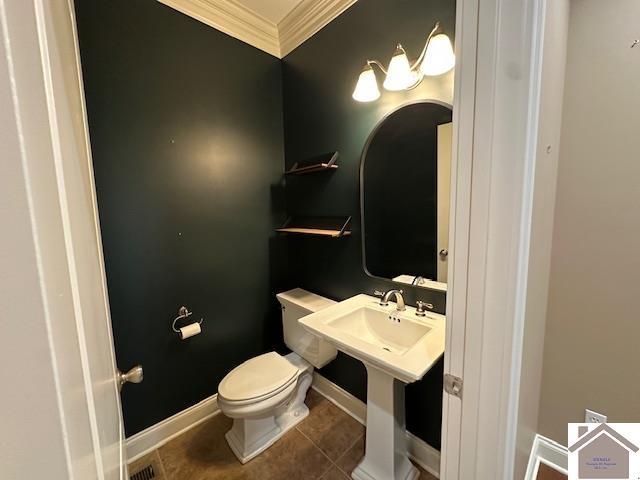 57 Rippling Creek Dr, Murray, KY 42071 - half bath with tile patterned floors, ornamental molding, toilet, baseboards, and visible vents