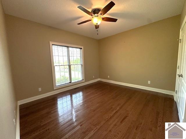 57 Rippling Creek Dr, Murray, KY 42071 - spare room with baseboards, ceiling fan, and dark wood-type flooring