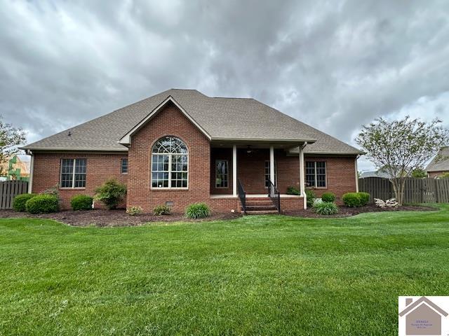 57 Rippling Creek Dr, Murray, KY 42071 - view of front of home featuring fence, a front yard, and brick siding