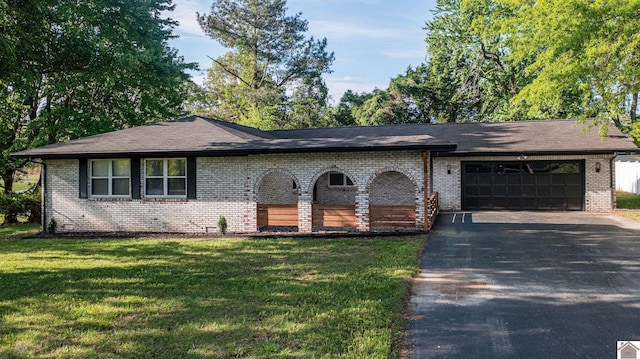 ranch-style home with a front yard, driveway, a garage, and brick siding