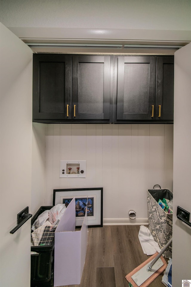 washroom featuring hookup for an electric dryer, cabinet space, washer hookup, and wood finished floors