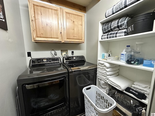 clothes washing area with cabinet space and independent washer and dryer
