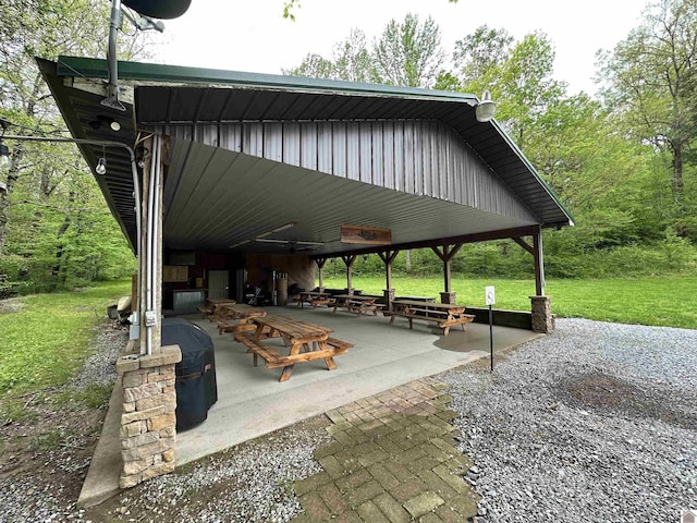 view of home's community with a lawn and a patio