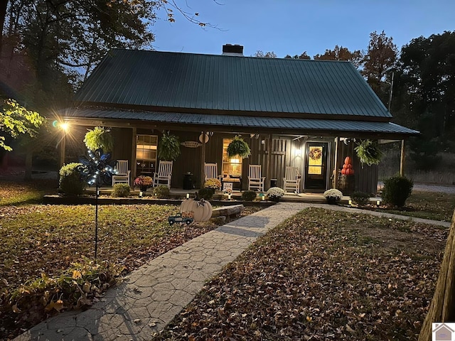 view of front facade featuring metal roof, a porch, and board and batten siding