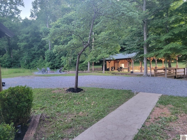 view of yard featuring a gazebo and a view of trees