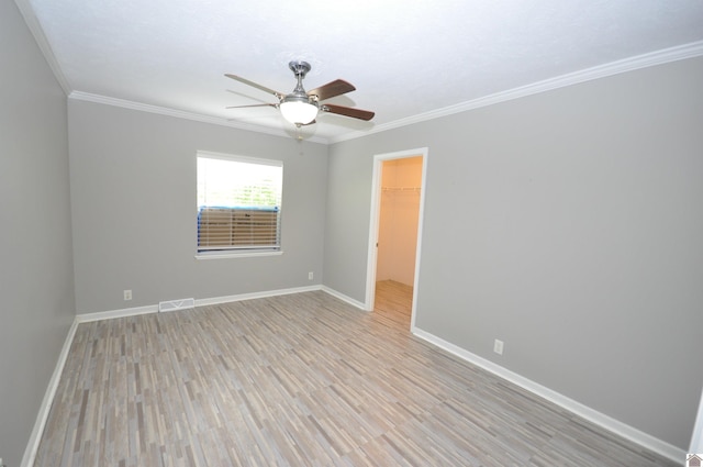 5770 Metropolis Lake Rd, West Paducah, KY 42086 - spare room with visible vents, ornamental molding, light wood finished floors, and ceiling fan