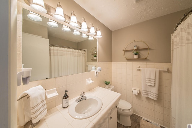 899 Fairview St, Benton, KY 42025 - full bath featuring tile patterned flooring, tile walls, a wainscoted wall, toilet, and vanity