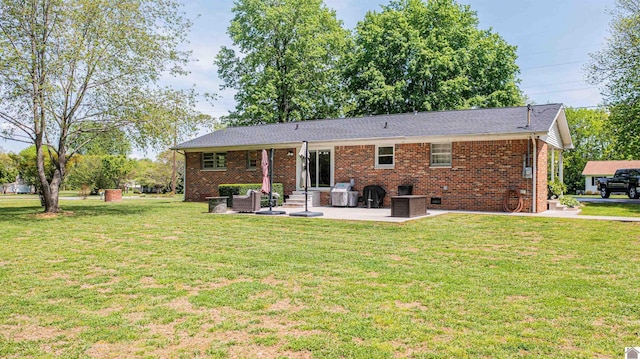 899 Fairview St, Benton, KY 42025 - back of house featuring a lawn, brick siding, and a patio area