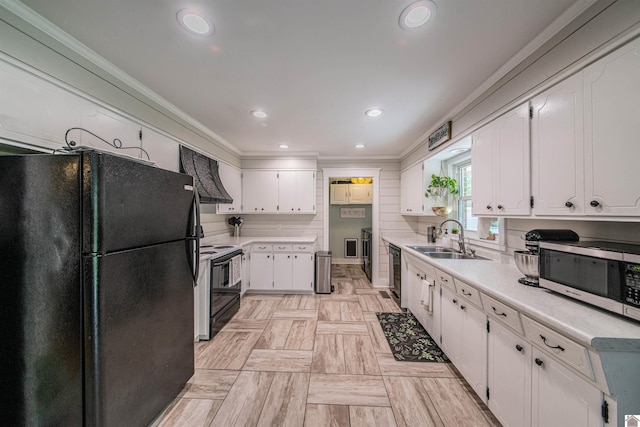 899 Fairview St, Benton, KY 42025 - kitchen featuring light countertops, wall chimney range hood, white cabinets, black appliances, and a sink
