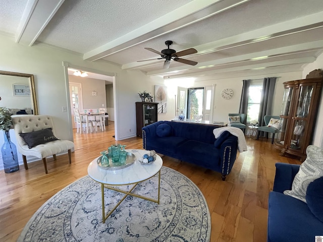 11189 E State Route 94, Murray, KY 42071 - living area featuring a textured ceiling, ceiling fan, light wood-style flooring, and beamed ceiling