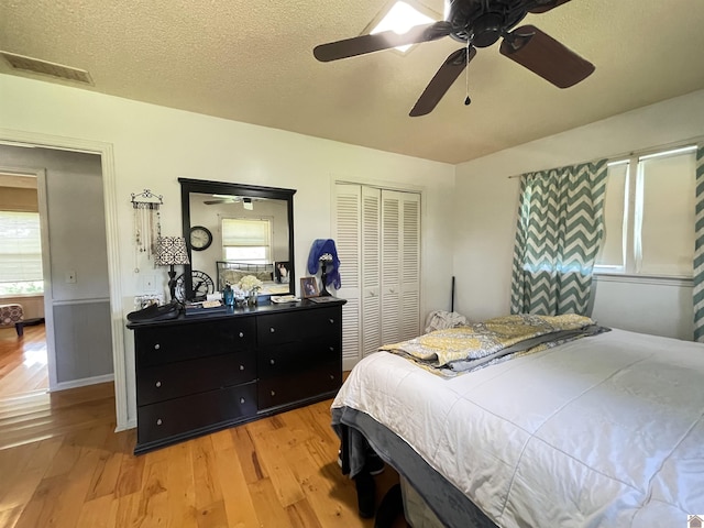 11189 E State Route 94, Murray, KY 42071 - bedroom with light wood finished floors, a closet, visible vents, and a textured ceiling