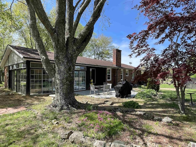 11189 E State Route 94, Murray, KY 42071 - back of house with a chimney, a patio, and a sunroom