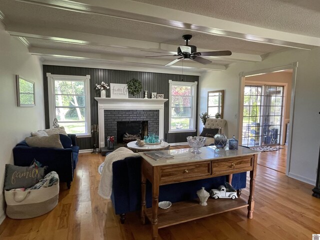 11189 E State Route 94, Murray, KY 42071 - living area with beamed ceiling, ceiling fan, a wealth of natural light, a textured ceiling, and wood finished floors