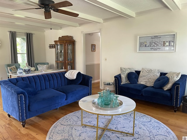 11189 E State Route 94, Murray, KY 42071 - living room with beamed ceiling, a ceiling fan, and wood finished floors