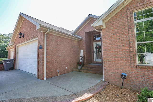 view of home's exterior with a garage, brick siding, and driveway