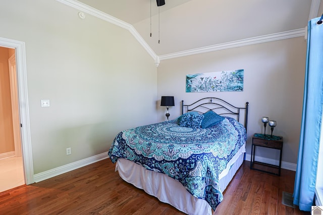 bedroom featuring baseboards, wood finished floors, and ornamental molding