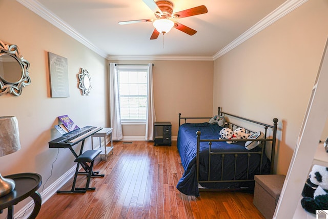 bedroom featuring hardwood / wood-style floors, baseboards, ornamental molding, and a ceiling fan