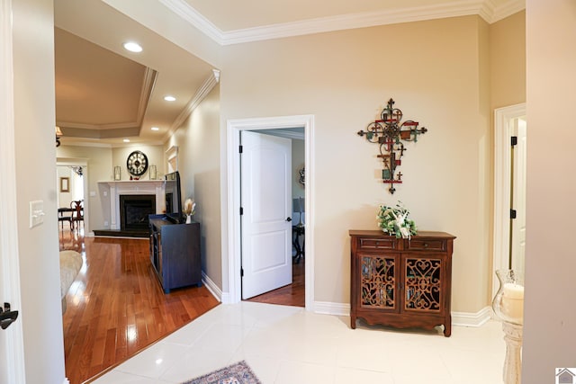 hall with ornamental molding, recessed lighting, wood finished floors, and baseboards