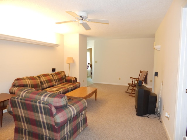 carpeted living room with ceiling fan