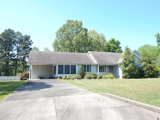 single story home with a front yard, driveway, an attached carport, and fence