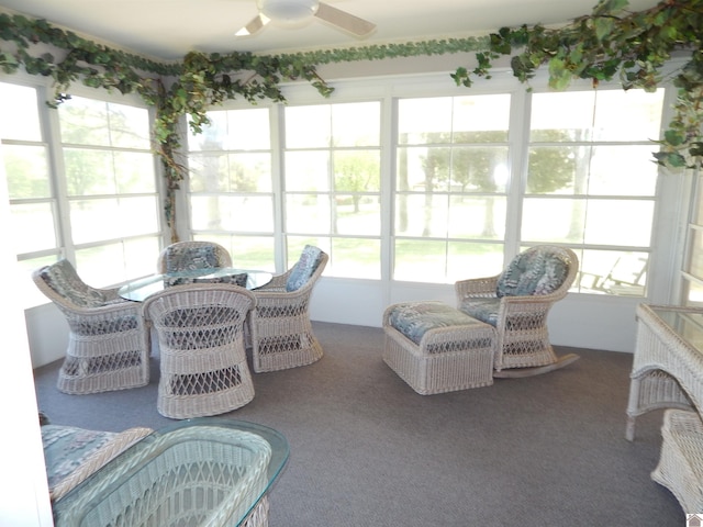 sunroom / solarium with a ceiling fan and outdoor dining area
