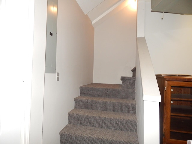 stairway with vaulted ceiling