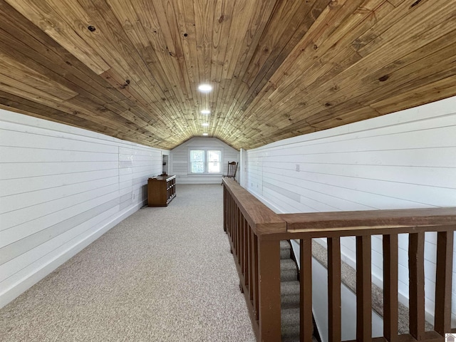 bonus room featuring lofted ceiling, wood walls, carpet floors, and wooden ceiling